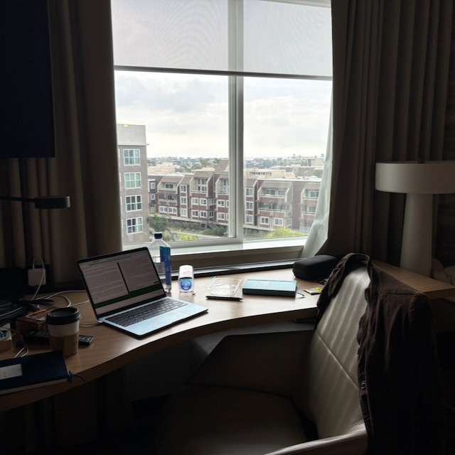 an image of a cluttered desk in a hotel room